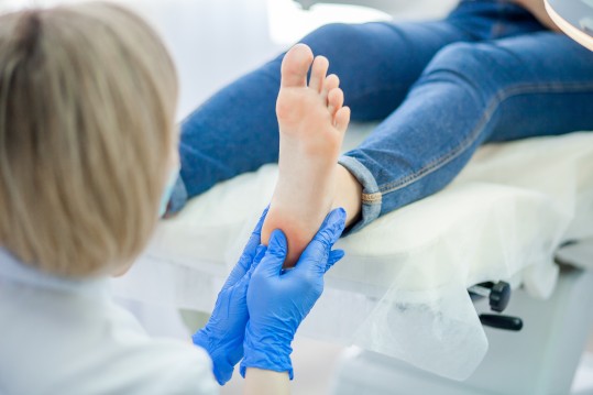 Southern Podiatry Nowra Podiatrist cutting toe nails and assessing foot pain